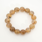 A luxury statement gemstone bracelet featuring original 15.60-15.61mm 10A+ VIP grade dark golden rutilated quartz round beads with international certification.