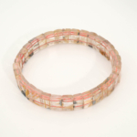 A luxury statement gemstone bracelet featuring original 5A+ grade golden rutilated quartz rolex-cut beads on a stretch band.