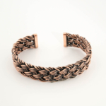 A handcrafted thick braided pure copper cuff bracelet with an oxidized antique finish for men and women.