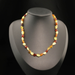 A certified original Baltic amber gemstone baby necklace (5-7g, 35-40cm) featuring colorful mix amber beads with safety knots.