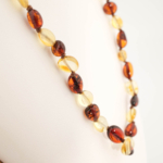 A certified original Baltic amber natural stone baby necklace (30-35cm, 4-7g) featuring smooth multicolored beads.