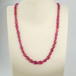 A high grade 7A+ natural faceted oval cut magenta red 51cm ruby gemstone necklace with 925 sterling silver clasp.
