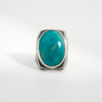 A 925 sterling silver handmade men's ring featuring a natural large oval cabochon cut Arizona blue turquoise gemstone.