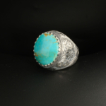 A 925 sterling silver handmade men's ring featuring a natural oval cabochon cut Arizona blue turquoise gemstone.