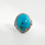 A 925 sterling silver handmade men's ring featuring a natural oval cabochon cut blue turquoise gemstone.