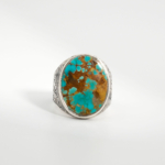 A 925 sterling silver handmade men's ring featuring a natural oval cabochon cut turquoise gemstone with brown matrix patterns.