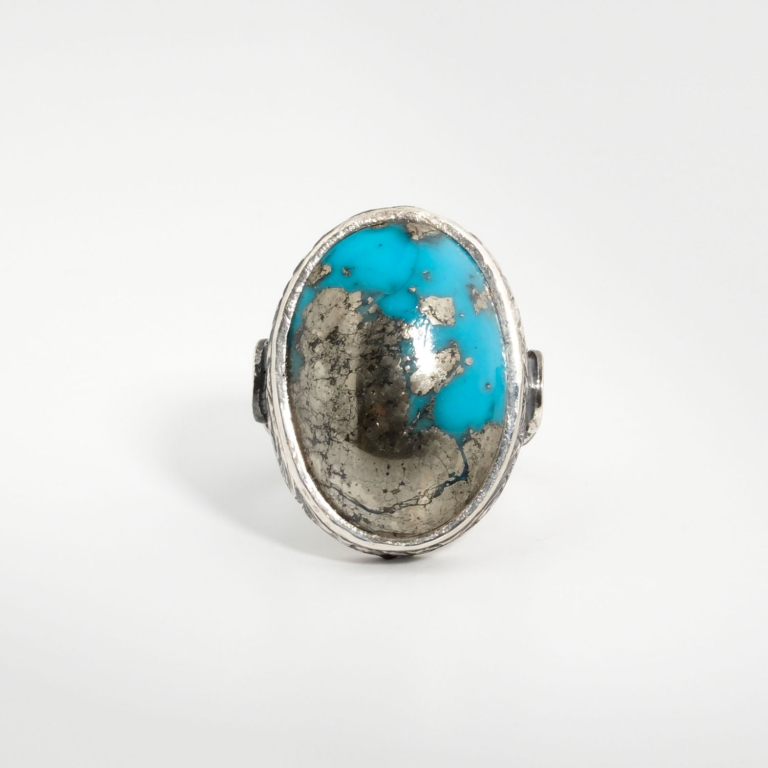 A 925 sterling silver handmade men's ring featuring a natural oval cabochon cut Nishapur turquoise gemstone with heavy metallic pyrite matrix.