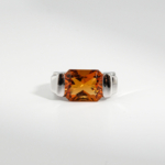 A 925 sterling silver unisex ring featuring an 8 ct natural horizontal radiant-cut orange citrine gemstone in a modern channel setting.