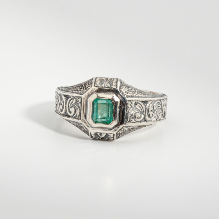 A 925 sterling silver handmade unisex ring featuring a natural square cut Zambian emerald gemstone.