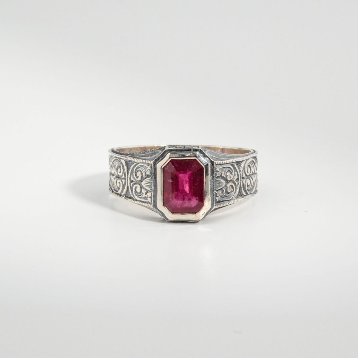 A 925 sterling silver handmade unisex ring featuring a natural rectangular cut red ruby gemstone.