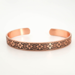 A pure copper handmade open cuff bracelet featuring floral patterns on top and Ayat al-Kursi inside.
