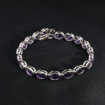A luxurious 18cm 925 sterling silver women's tennis bracelet featuring oval faceted natural purple amethyst gemstones.