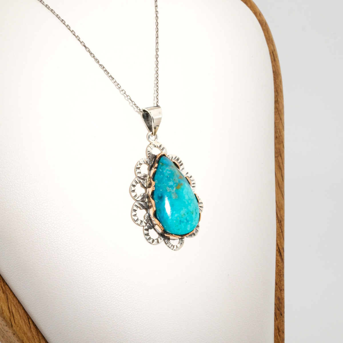 A 925 sterling silver handmade teardrop pendant featuring a natural blue-green chrysocolla gemstone.