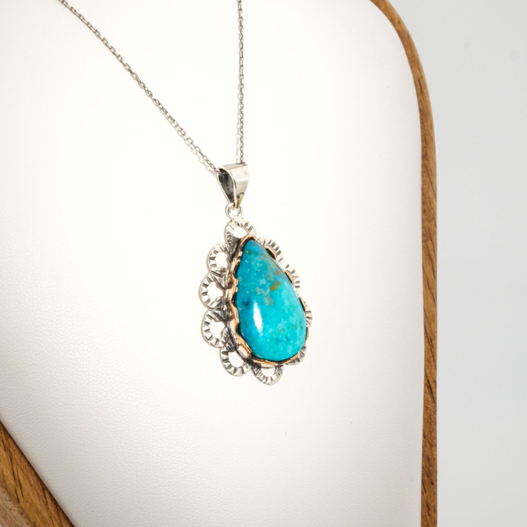 A 925 sterling silver handmade teardrop pendant featuring a natural blue-green chrysocolla gemstone.