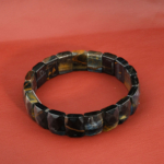 A natural faceted rolex cut blue and golden tiger's eye gemstone unisex stretch bracelet.