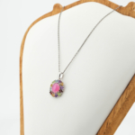 Natural multi gemstone halo pendant necklace with center cabochon pink ruby and faceted gemstones in 925 sterling silver.