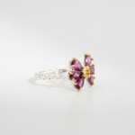 A 925 sterling silver women's ring featuring pear-shaped natural pink rubellite tourmaline gemstones set in a flower design with gold-plated prongs.
