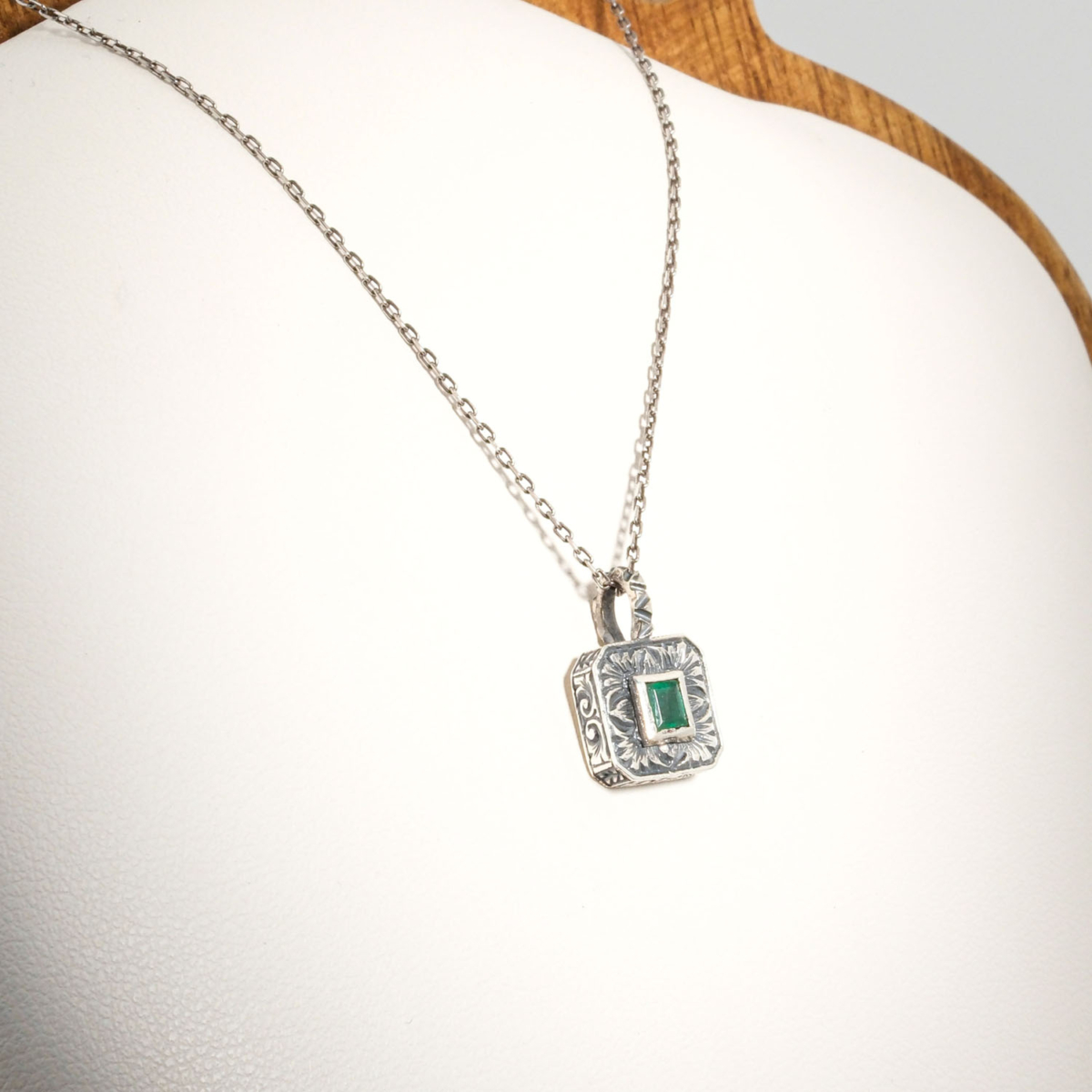 A 925 sterling silver handmade unisex pendant featuring a natural square cut Zambian emerald gemstone.