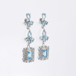 A pair of original blue topaz natural stone 925 sterling silver dangle drop earrings featuring baguette and pear cuts.