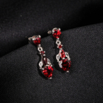 A pair of original heart cut garnet natural stone 925 sterling silver dangle drop earrings with zircon accents.