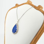 925 sterling silver women necklace featuring a pear shaped natural blue lapis lazuli gemstone with enamel and zircon halo.