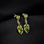 A pair of original heart cut peridot natural stone 925 sterling silver dangle drop earrings with zircon accents.