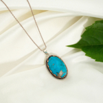 A 925 sterling silver handmade unisex pendant featuring a natural oval cabochon cut blue turquoise gemstone.
