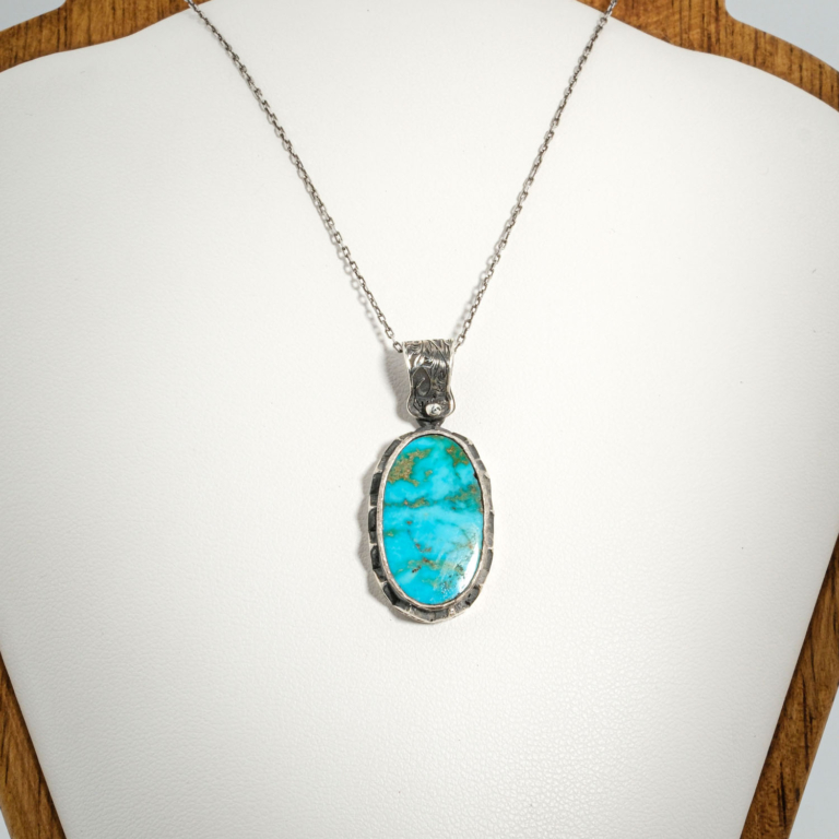 A 925 sterling silver handmade unisex pendant featuring a natural oval Nishapur turquoise gemstone.