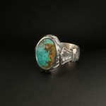 A 925 sterling silver handmade men's ring featuring a natural oval cabochon cut Nishapur turquoise gemstone with brown matrix patterns.