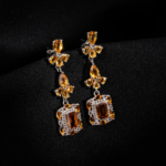 A pair of original citrine natural stone 925 sterling silver dangle drop earrings featuring baguette and pear cuts.