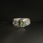 A 925 sterling silver handmade unisex ring featuring a natural baguette cut green peridot gemstone.