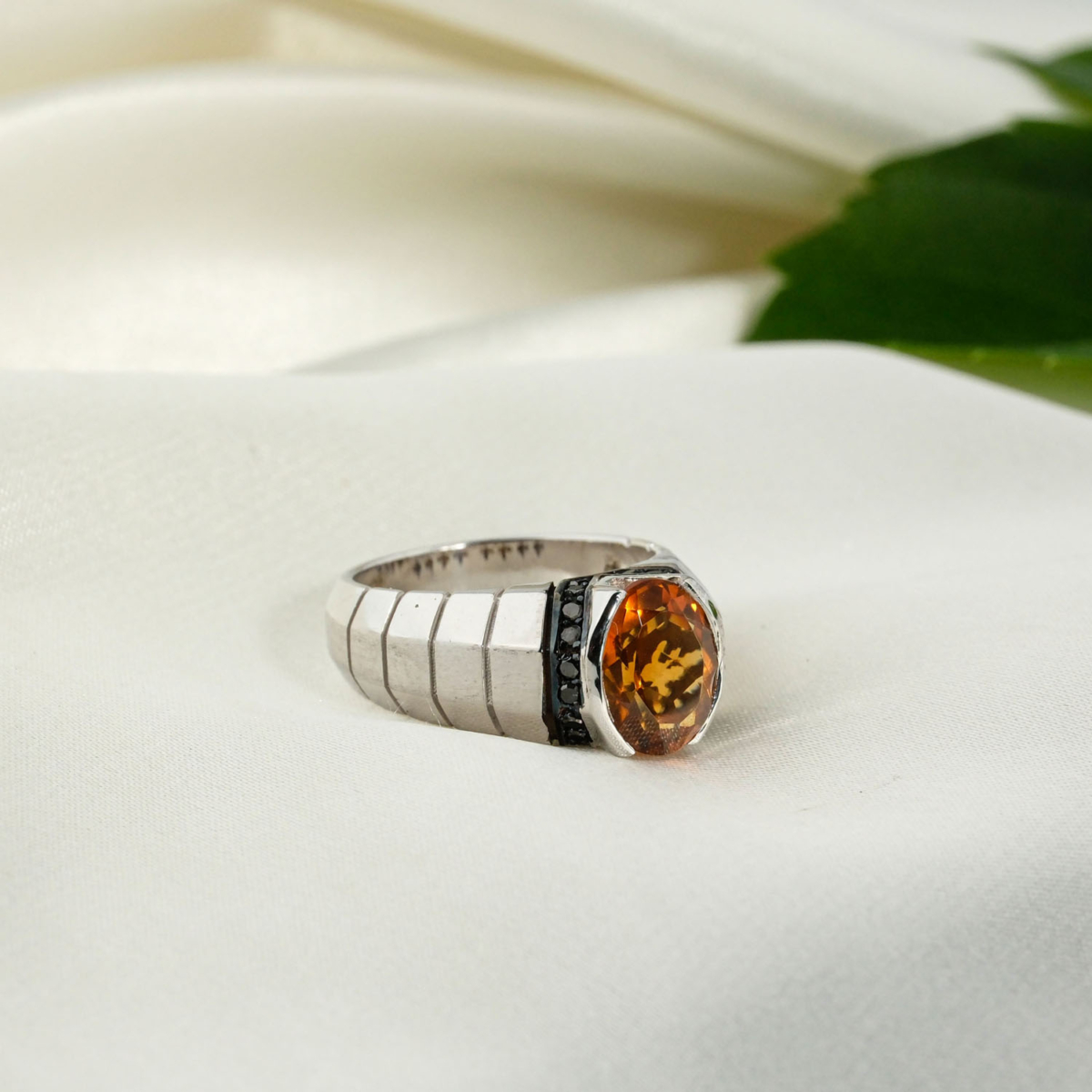 A 925 sterling silver handmade unisex ring featuring a natural oval faceted orange citrine gemstone flanked by black diamonds.