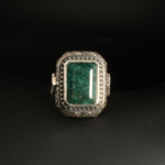 A 925 sterling silver handmade men's ring featuring a natural emerald cut dark green emerald gemstone.