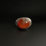 A 925 sterling silver handmade men's ring featuring a natural oval cabochon cut translucent red-orange Yemeni agate gemstone.