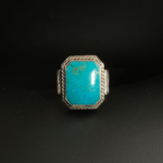 A 925 sterling silver handmade men's ring featuring a natural rectangular cut Arizona blue turquoise gemstone.