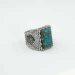 A 925 sterling silver handmade men's ring featuring a natural rectangular cut blue-green turquoise gemstone.