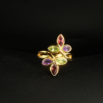 A gold-plated 925 sterling silver women's ring featuring a leaf branch design set with marquise-cut amethyst, garnet, and peridot gemstones.