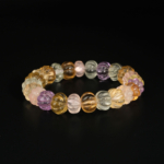 A natural gemstone stretch bracelet featuring 8.5x11.5mm carved melon beads of citrine, rose quartz, lemon quartz, amethyst, and fluorite.
